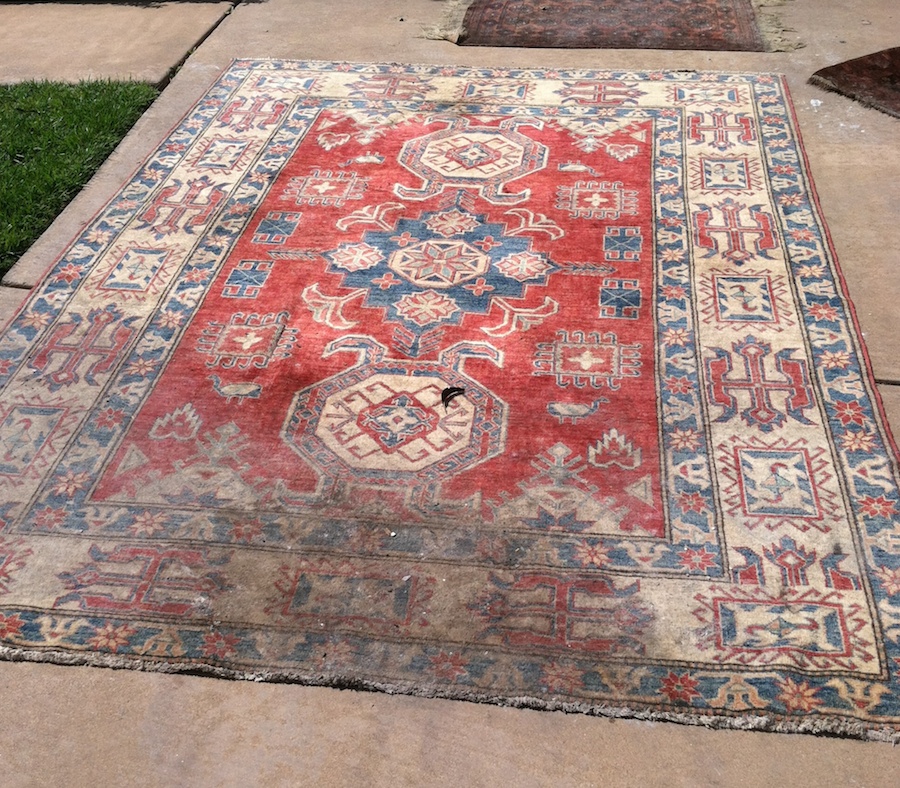 Soot and smoke damage on a Pakistan wool rug.