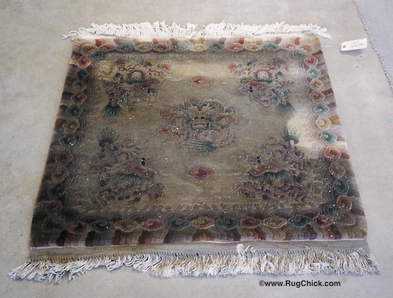 Heavier smoke/soot damage to a Chinese wool rug. 