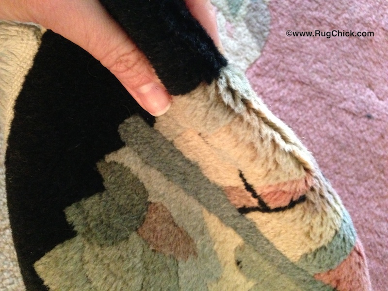 Every woven rug has a pile direction. Determine which fringed end the pile is pointing toward.