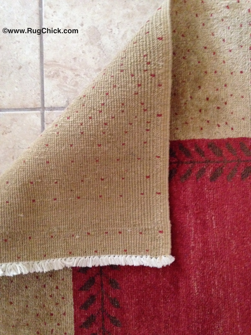 This rug has some buckling/wrinkles that are often present in tribal rugs.