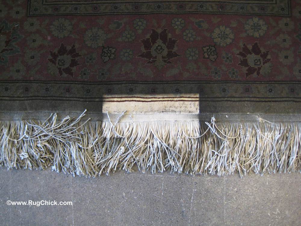 A heavy lamp on the edge of the rug created one small unaffected area.