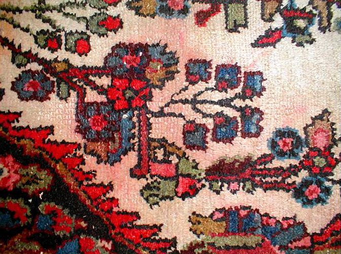 Red dye has bled on the top side of this rug only from an old spill.