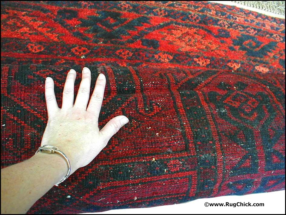 Creases can be clearly seen on the back of this Afghan rug. These are causing buckling on the front.