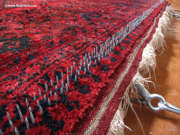 Stretching an Afghan rug to help it lay flatter.