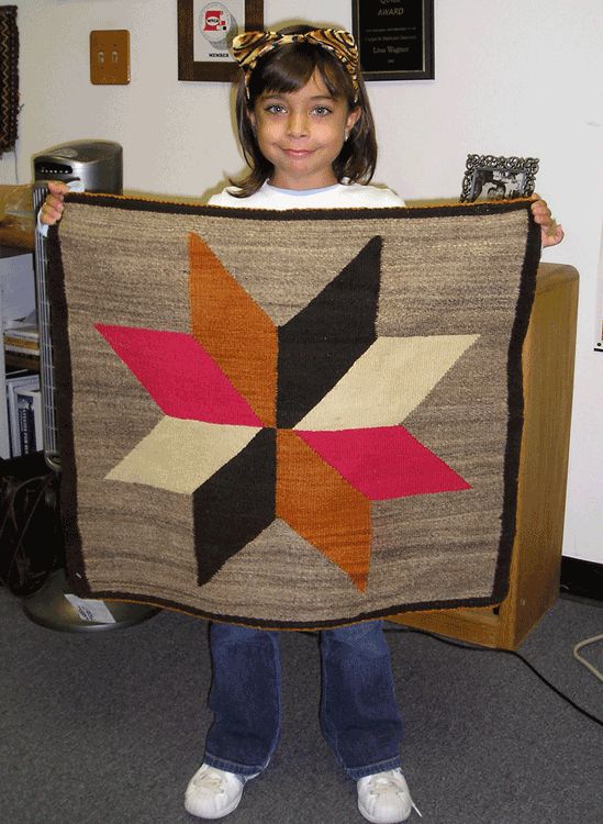 My niece Katie (when she was little) with a little Navajo weaving.