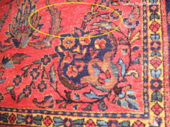 White knots and a little bit of field wear on this Sarouk rug may be left alone because it is expected in a rug of this age, and is not very noticeable at all.