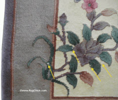 A few white cotton foundation strands peek through on this Chinese rug.