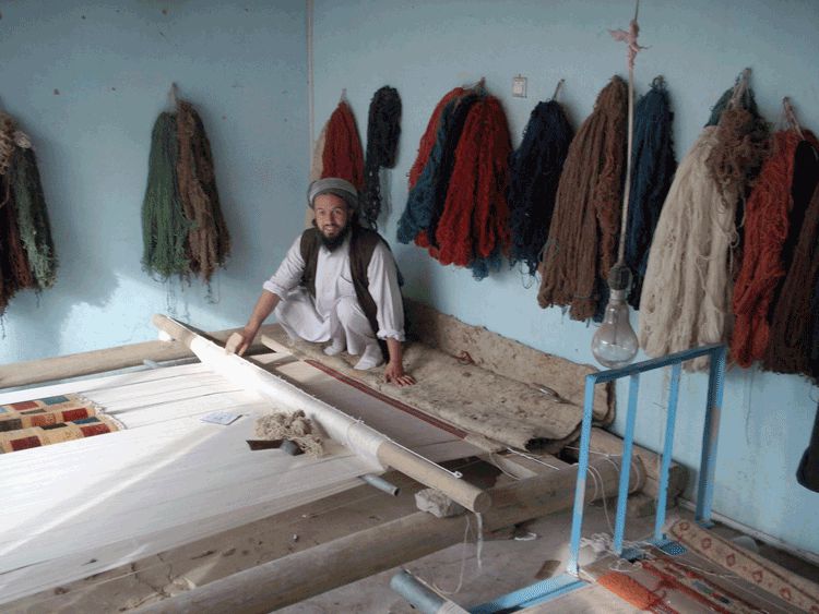 Weaver using a horizontal loom.