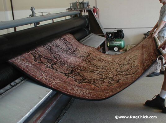 Rug through roller wringer. Safely and quickly removes the excess water and flattens out the rug for quick drying.